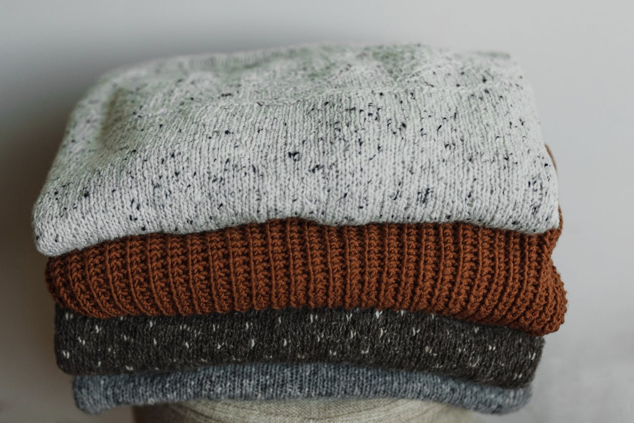 A Close-up Shot of Stack of Folded Knitted Fabrics